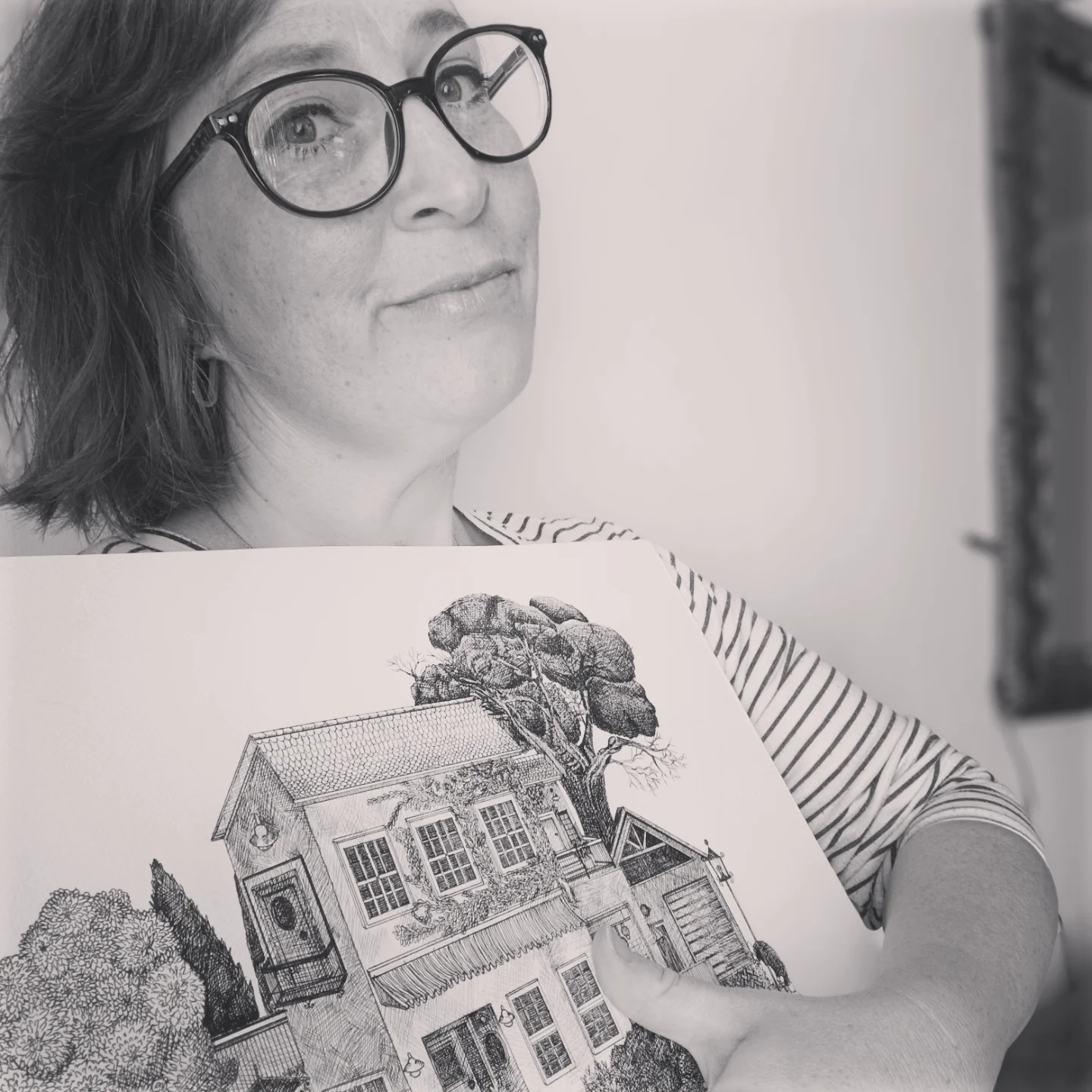 Laurita le Roux holding one of her townscape drawings